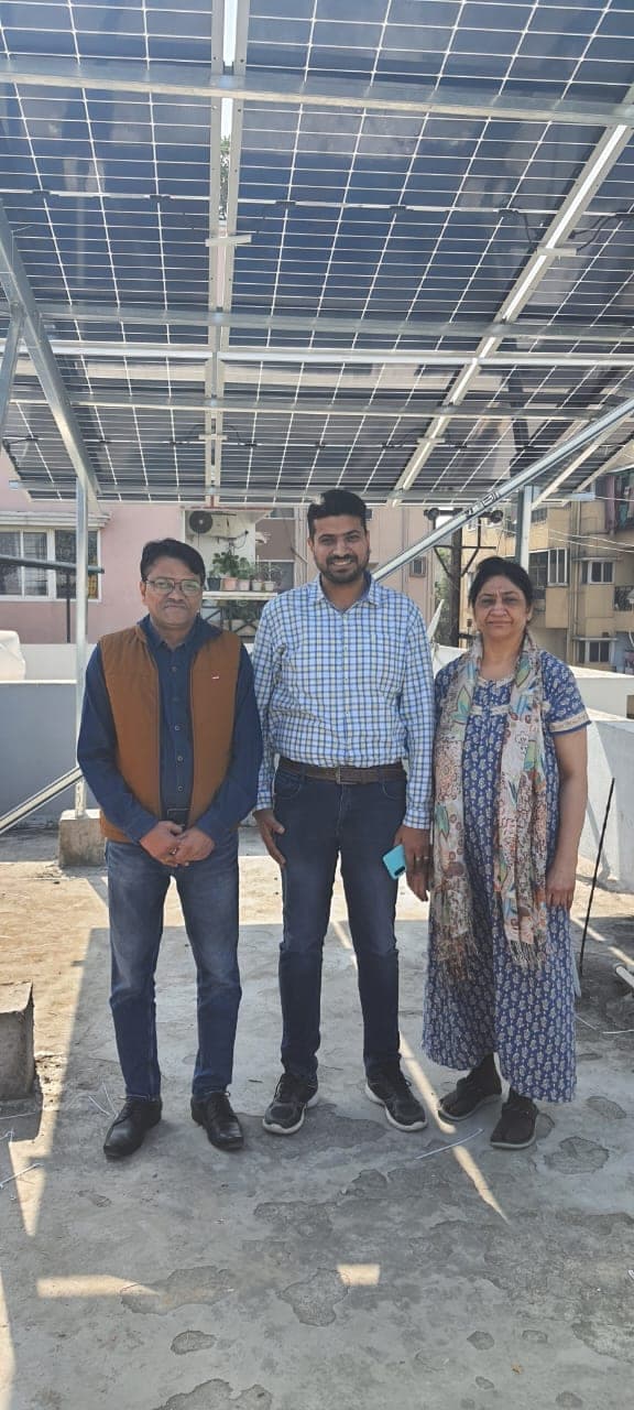 Family with Genius Solar representative at the handover of their rooftop solar system, Indore