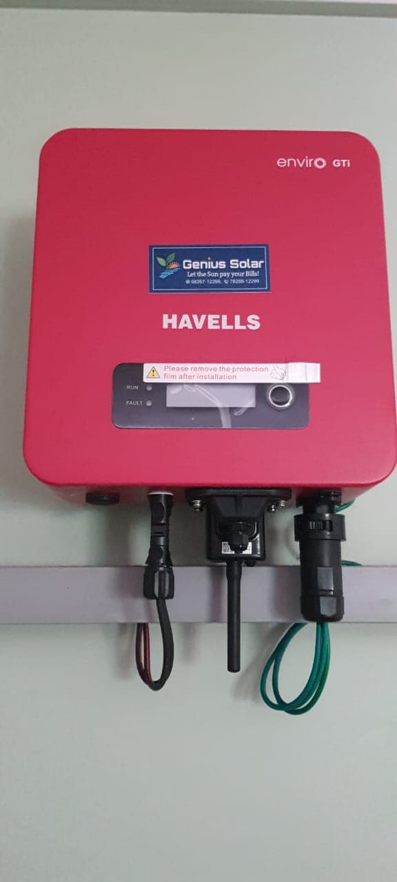 Havells Enviro grid-tied solar inverter wall-mounted with DC and AC cabling, installed by Genius Solar, Indore
