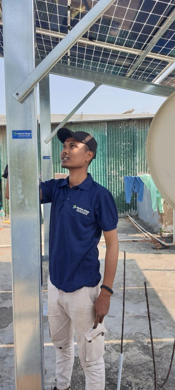 Genius Solar technician fastening a galvanised solar structure member on an Indore rooftop